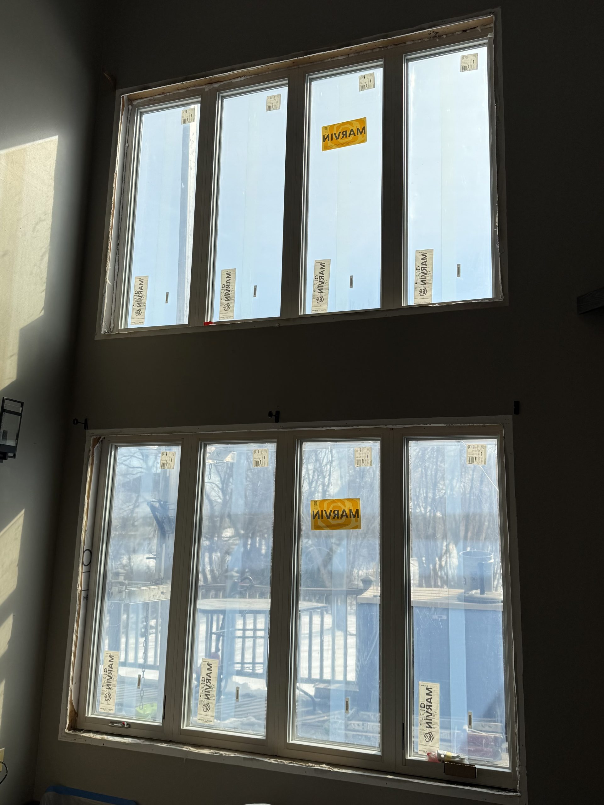 Newly installed Marvin casement windows in an Albertville, MN home, factory labels still on the glass