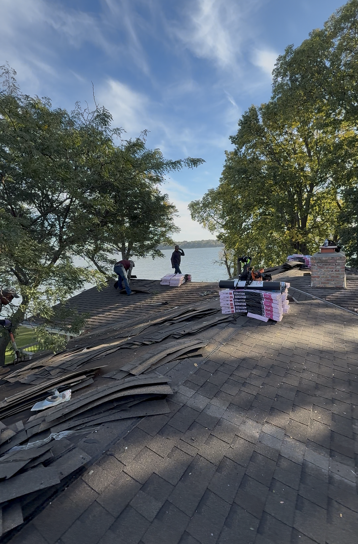 Cohen Construction crew replacing a lakeside roof in Minnetonka, MN