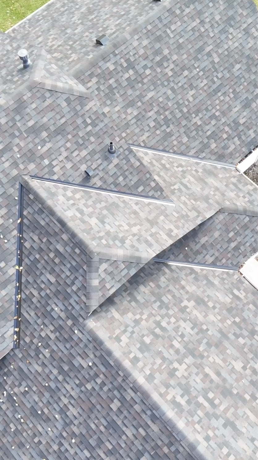 Aerial view of a finished shingle roof with valleys on a Dayton, MN home