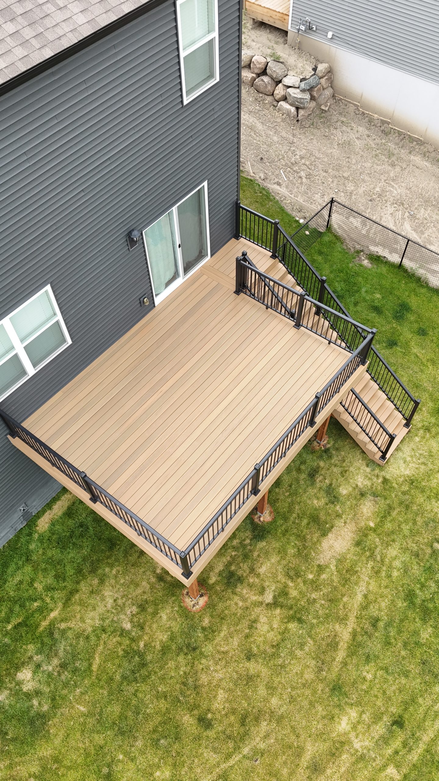 Aerial view of a new composite deck with black railings built by Cohen Construction