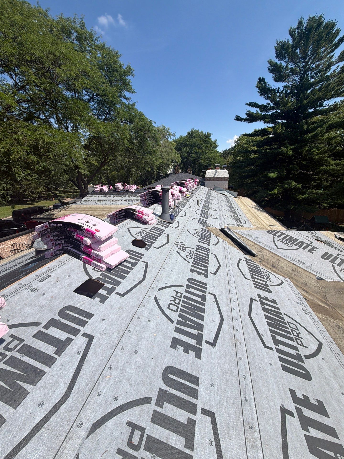 Shingle bundles staged on new roof decking during a roof replacement in Minneapolis, MN